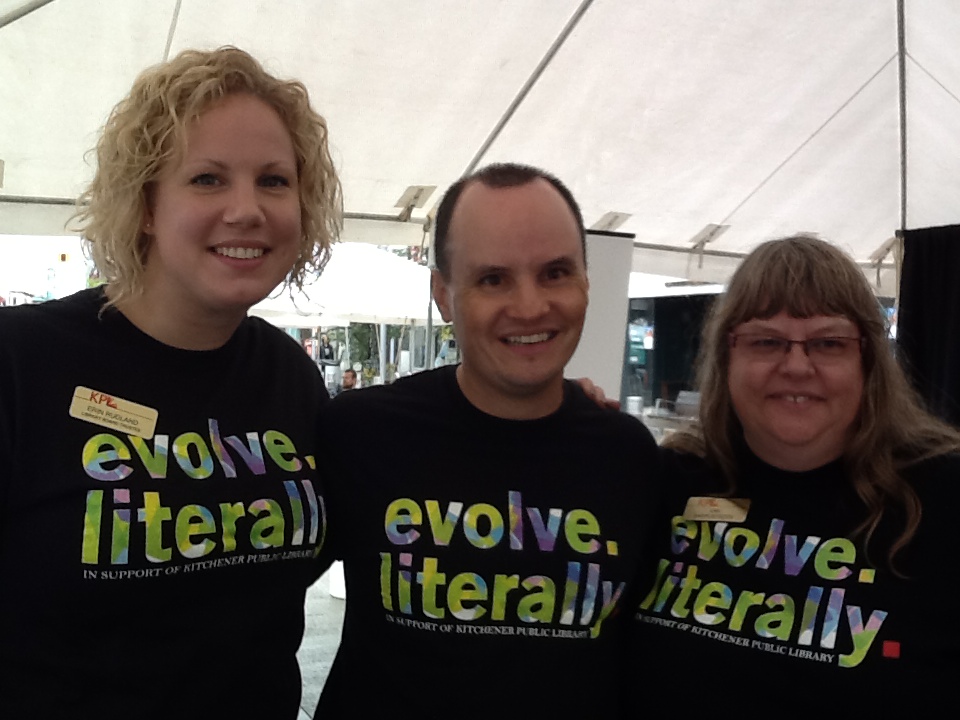 Two women and one man in evolve literally tshirts