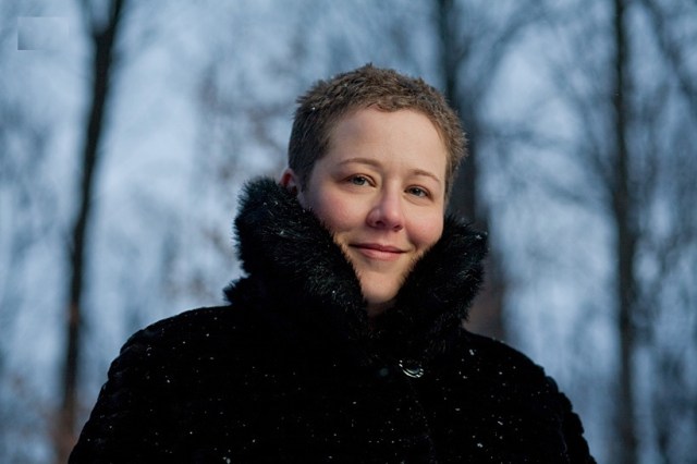 Woman in falling show with collared winter coat