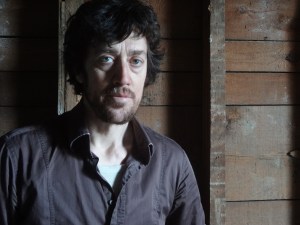 Man in front of brick wall