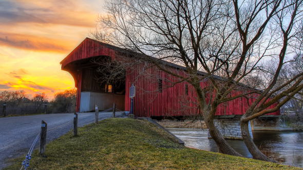 red covered bridge at sunset