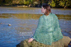 Woman in green shawl at river