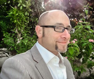 Man in grey jacket with glasses