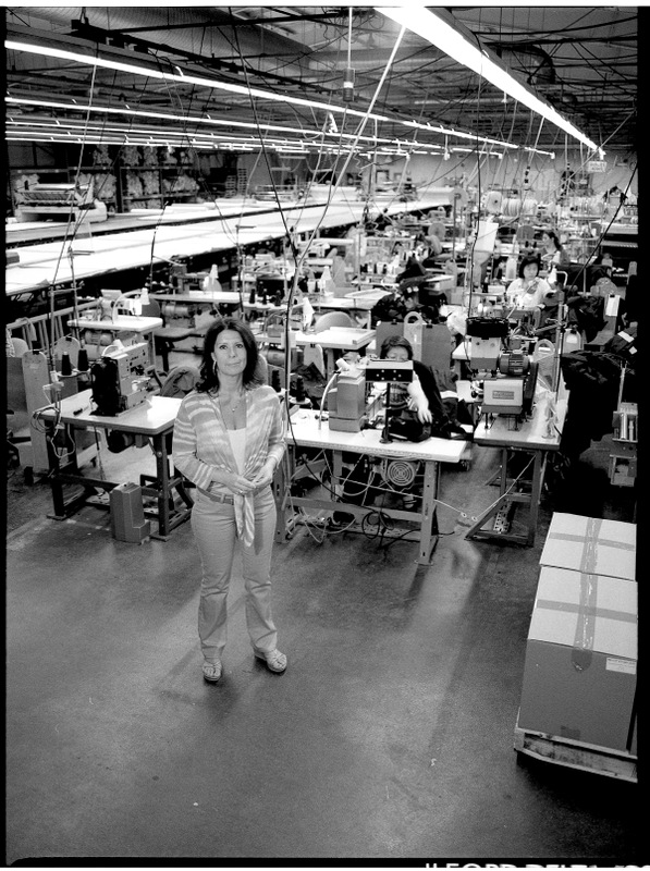 Black and white - woman standing in garment factory