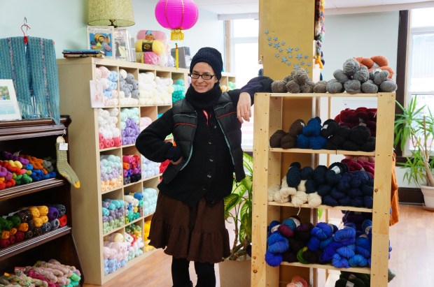 Woman in front of colourful wool display