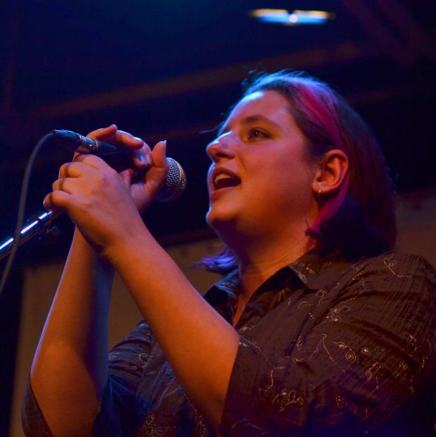Woman singing into mic