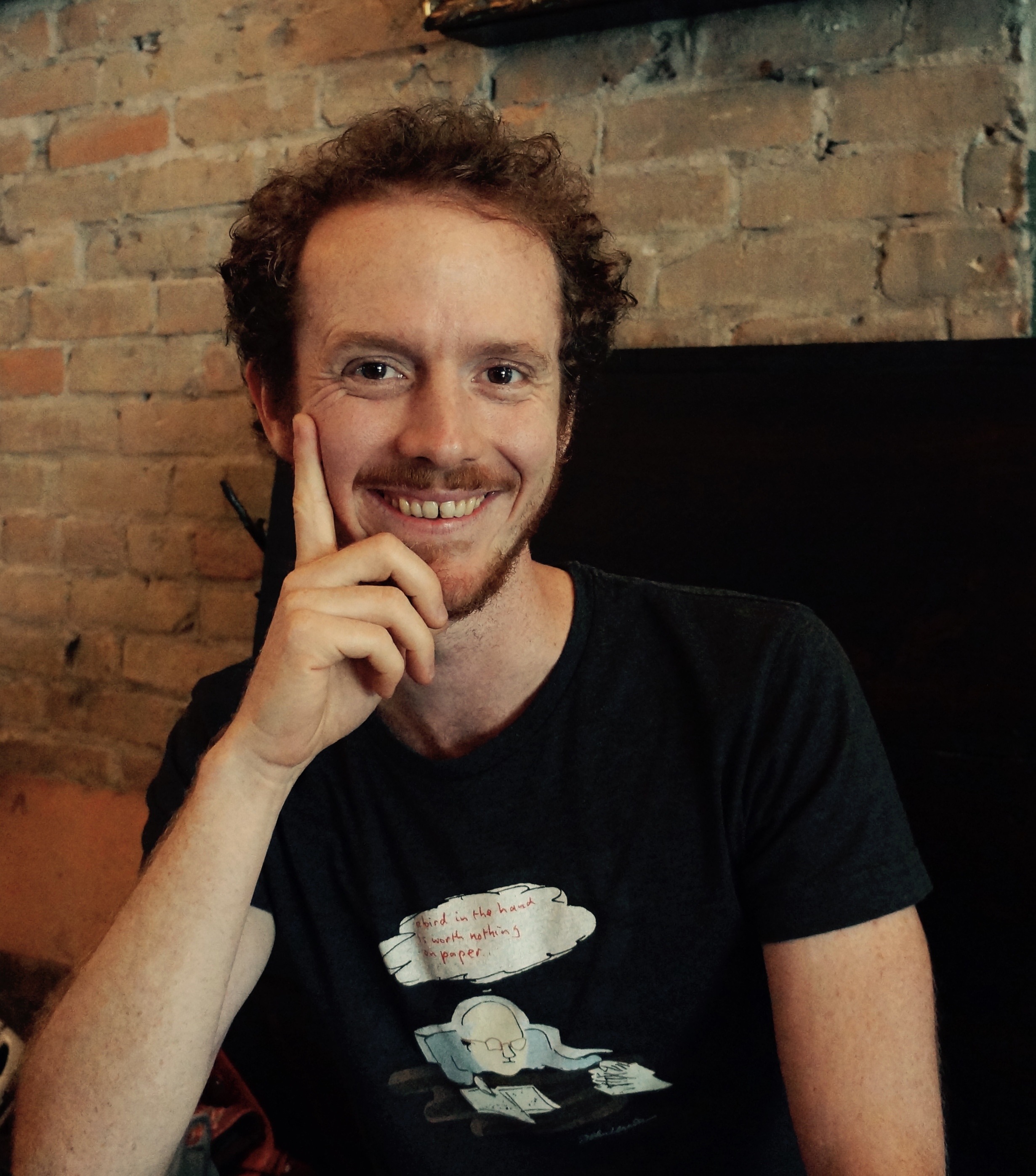 Main with red hair in cafe