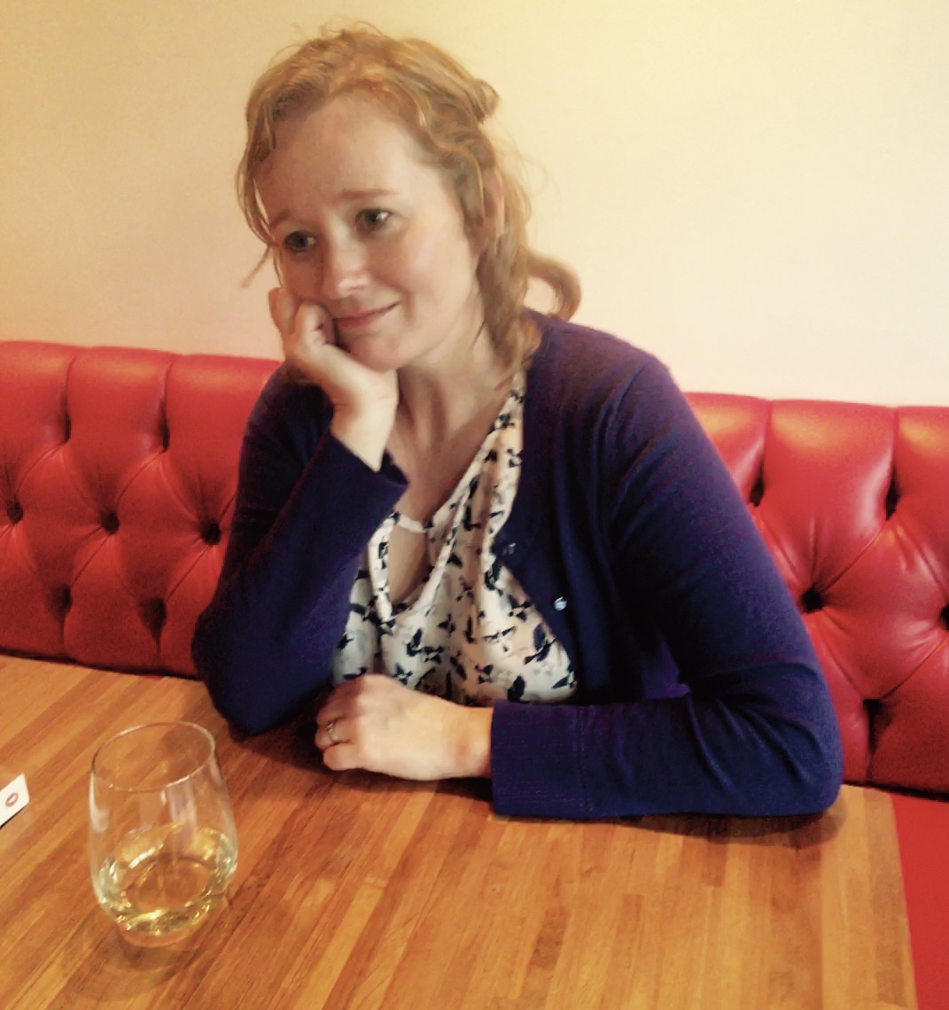 Woman sitting in red leather booth
